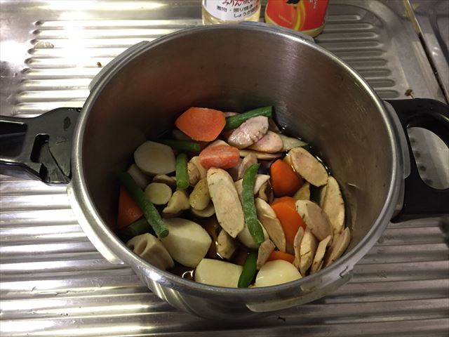 切った野菜と冷凍食品のカット野菜と調味料を圧力鍋に入れる